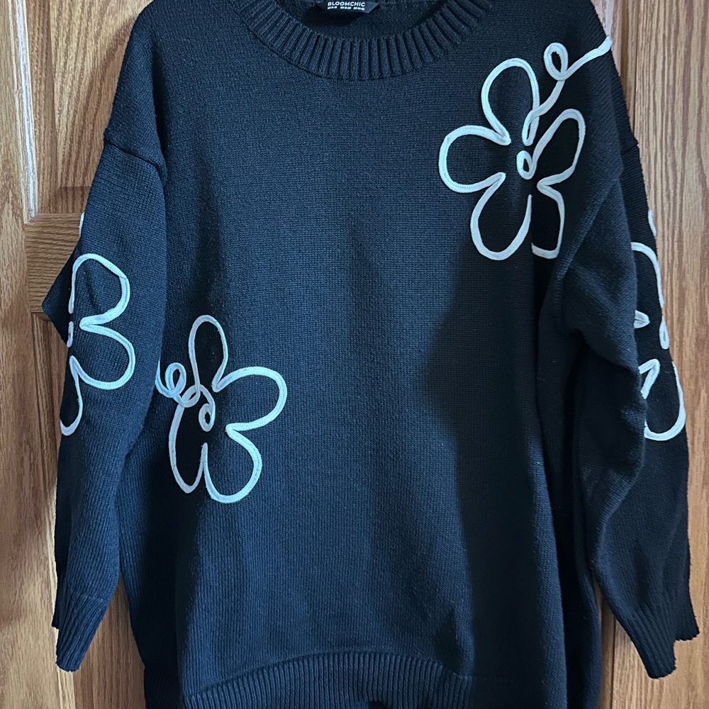 BloomChic Black Sweater with White Floral Design